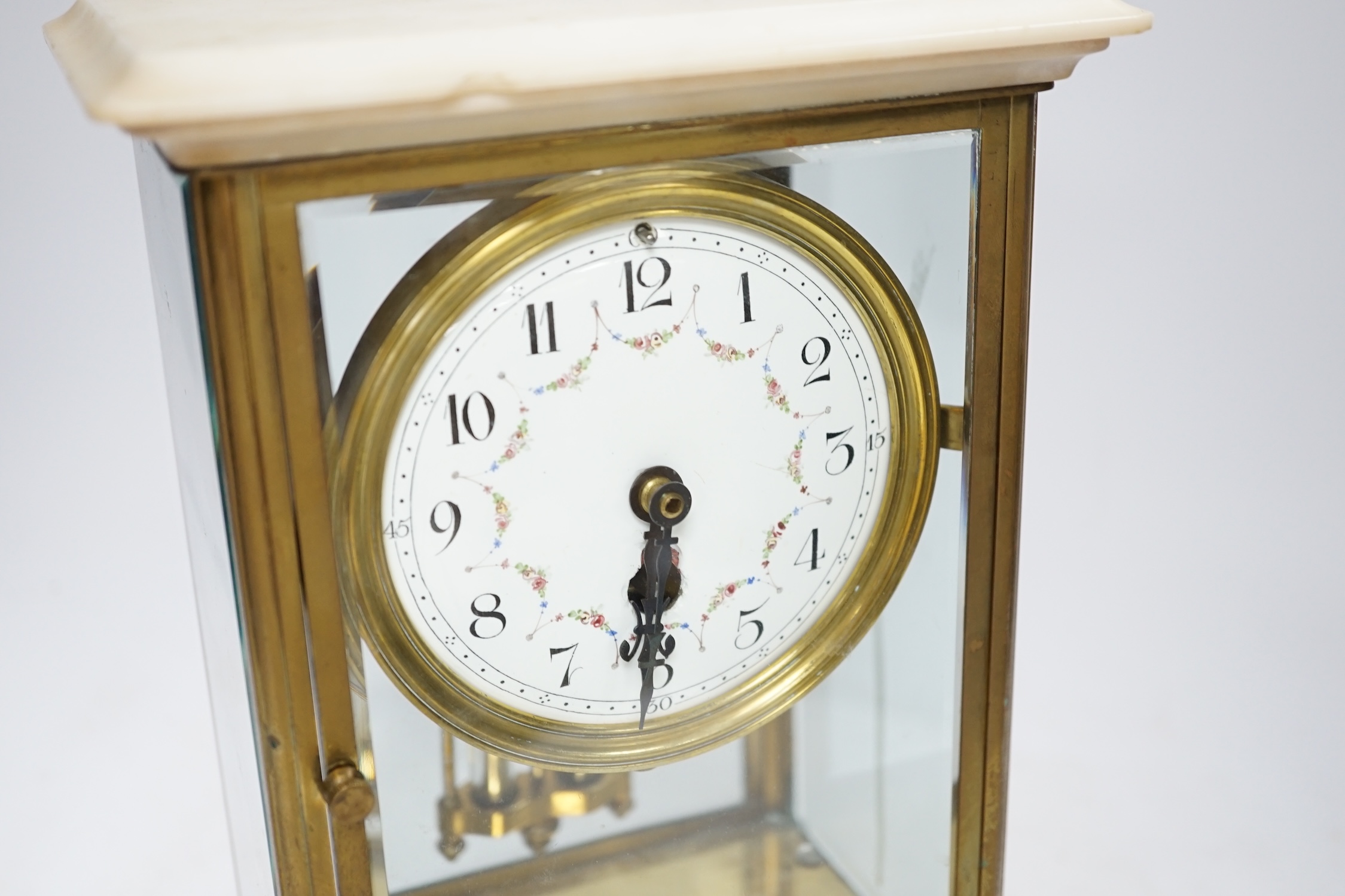 A French lacquered brass and marble, enamelled dial, four glass mantel clock, 30cm high